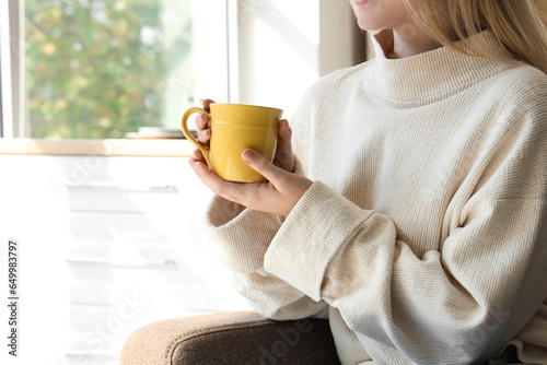 Young woman with cup of hot...