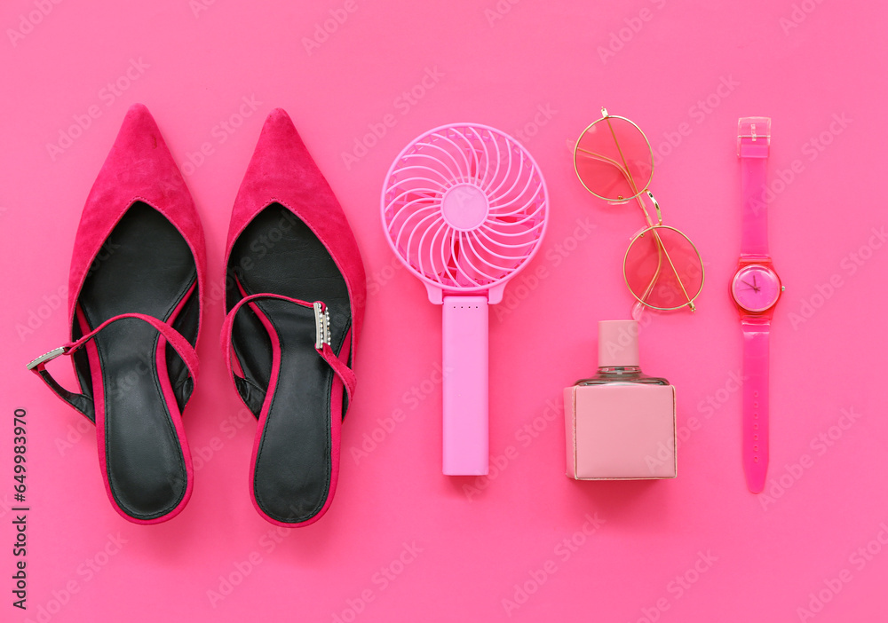 Composition with portable electric fan and stylish female accessories on pink background