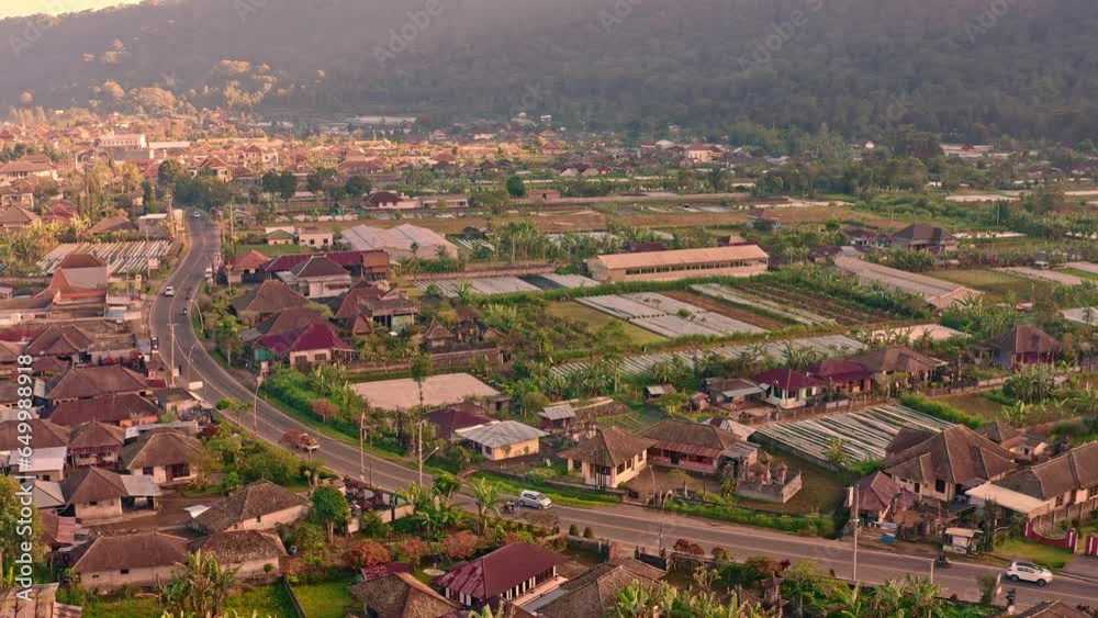 Silhouette travel people driving by scenic road Bali to major water temple Bali Pura Ulun Danu Bratan Bali, Indonesia 4K Aerial view Silhouette travel people driving by scenic road Bali to major water temple Bali Pura Ulun Danu Bratan Bali, Indonesia 4K Aerial view