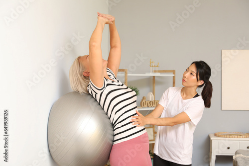 Personal trainer assisting ...