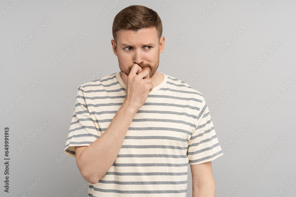 Stressed nervous man thoughtful thinking of problem solution with unhappy face expression. Doubtful depressed guy staring at one point pensive of important decision has life trouble, isolated on grey Stressed nervous man thoughtful thinking of problem solution with unhappy face expression. Doubtful depressed guy staring at one point pensive of important decision has life trouble, isolated on grey