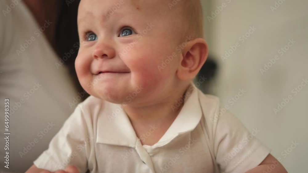 Happy baby. Cute little newborn girl with smiling face crawling on couch in bedroom. Emotional infant baby smiling resting playing on sofa at home. Motherhood happy child childcare concept Happy baby. Cute little newborn girl with smiling face crawling on couch in bedroom. Emotional infant baby smiling resting playing on sofa at home. Motherhood happy child childcare concept