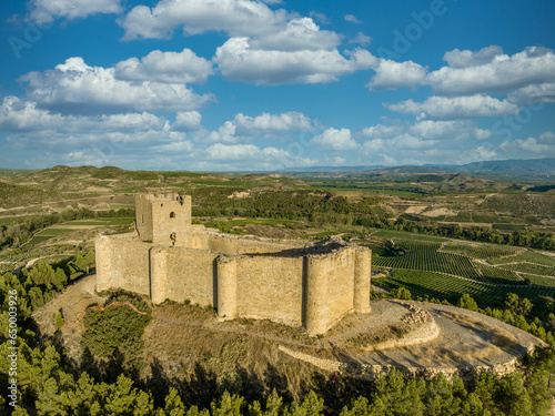 Aerial view of Davalillo castle above the Ebro river in Rioja Spain, with semicircular towers and tower of homage medieval defensive residential building, blue cloudy sky background photo