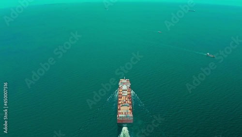 4K resolution high angle view of a container ship sailing at the sea for transportation.