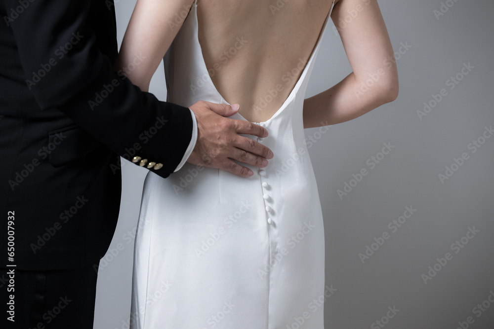 A man's hand escorting a woman.