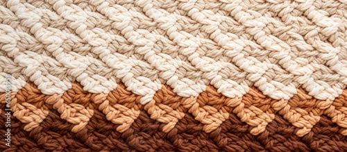 Gradient in knitting creates a beige and brown handmade rug with textured patterns