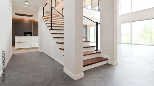 A staircase leading up to the second floor is built in the middle of the living room, giving it a palace-like feel