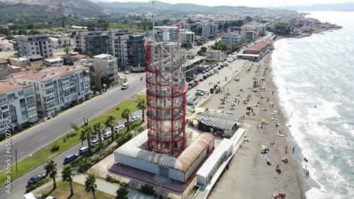 drone footage of Marine radar tower at the beach in izmir, blue eagean sea with a beach next to it photo