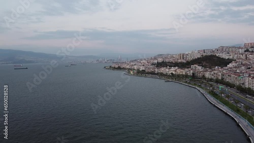 Aerial drone video of goztepe izmir with mountain, eagean sea in the background at sunset with traffic flow photo