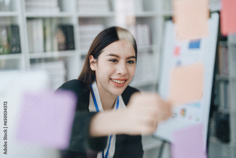 Beautiful young teen asian businesswoman using note pad thinking with planning working on financial document, tax, exchange, accounting and Financial advisor Beautiful young teen asian businesswoman using note pad thinking with planning working on financial document, tax, exchange, accounting and Financial advisor