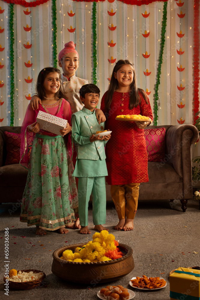 Group of children holding sweets and gifts during the festival of Diwali