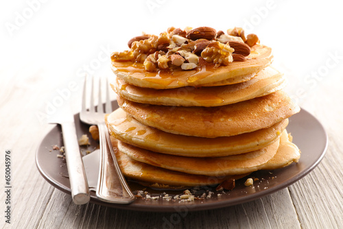 Homemade american pancakes with dried nuts and syrup