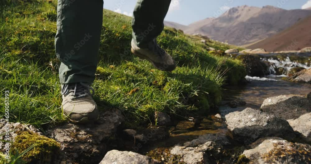 Mountain stream, stream crossing, feet in sneakers, slow motion. Arashan. Legs close-up in wet sneakers, crossing stream over stones. Atmosphere of amazing nature, breathtaking. Travel in happiness. Mountain stream, stream crossing, feet in sneakers, slow motion. Arashan. Legs close-up in wet sneakers, crossing stream over stones. Atmosphere of amazing nature, breathtaking. Travel in happiness.