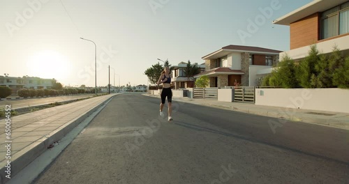 Wallpaper Mural Dawn Fitness Routine: Active Woman Engaging in Morning Jog Through Urban Environment in Sporty Attire. High quality 4k footage Torontodigital.ca
