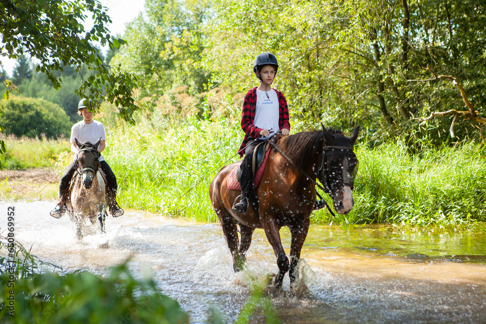 Φωτογραφία Horse ride, young girls riders, crossing a river, a stream on horseback, splashes from horse hooves, a picturesque place