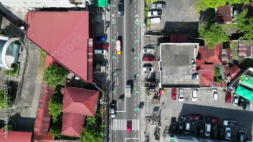 Aerial top-down view of busy traffic with trucks and motorcycles driving across town roads in Legazpi, Albay. photo