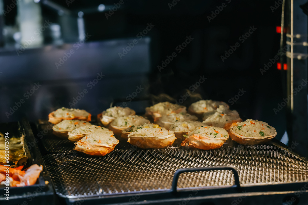 Grilled crab with cheese at Dongmun Market in Jeju Island, South Korea. This market is one of Jeju famous tourist spot.