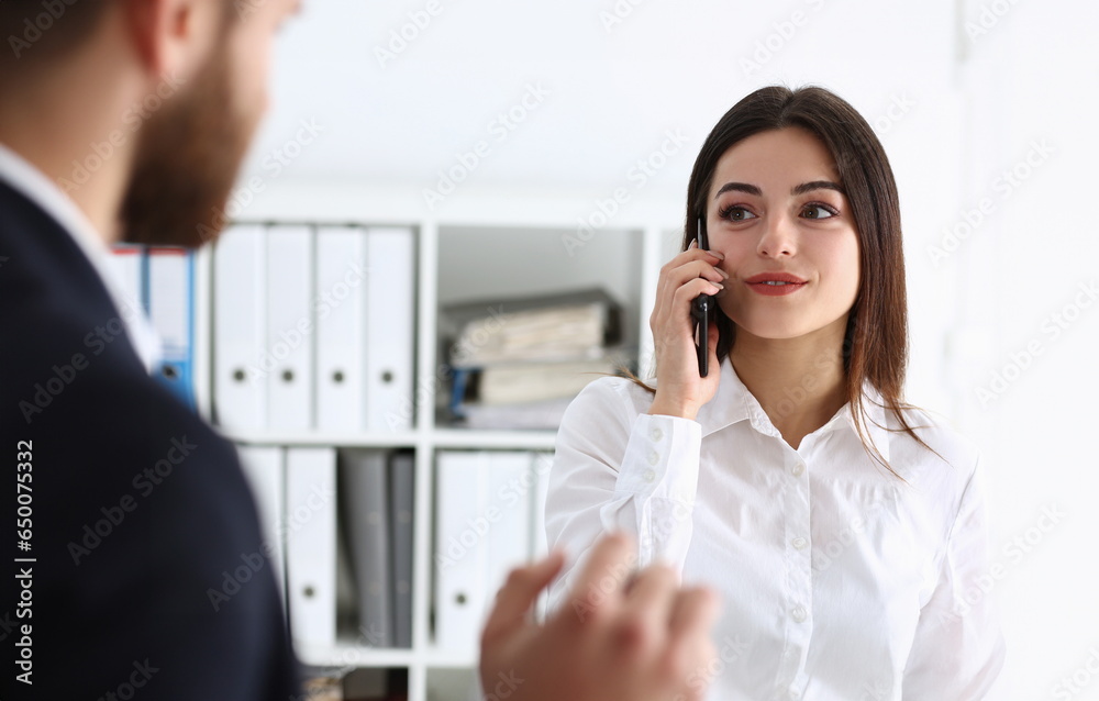 Fototapeta premium Beautiful brunette smiling businesswoman talk cellphone in office portrait. Stay in touch negotiate meeting job white collar busy life style electronic device store professional training concept