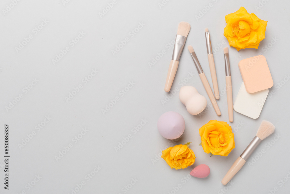 Makeup brushes and sponges on color background, top view Makeup brushes and sponges on color background, top view