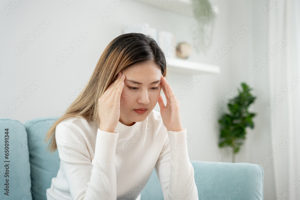 Headache, female having migraine pain, bad health, Asian woman feeling stress and headache, Office syndrome, sad tired touching forehead having migraine or depression, irritated girl, sadness grie Headache, female having migraine pain, bad health, Asian woman feeling stress and headache, Office syndrome, sad tired touching forehead having migraine or depression, irritated girl, sadness grie