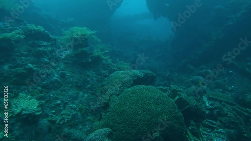 Inside the remains of shipwreck, underwater slow motion photo