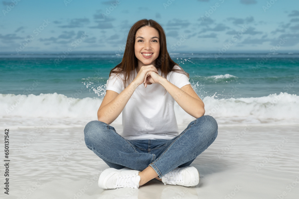 Attractive young woman sitting on the beach, vacation