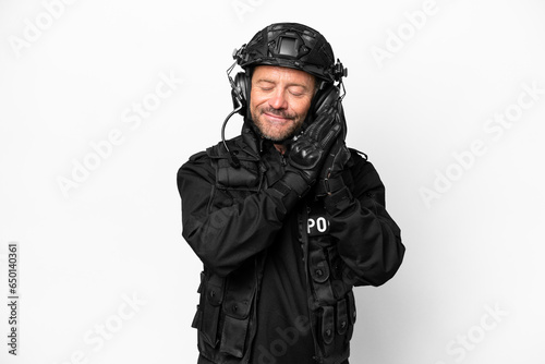 Middle age SWAT man isolated on white background making sleep gesture in dorable expression © luismolinero