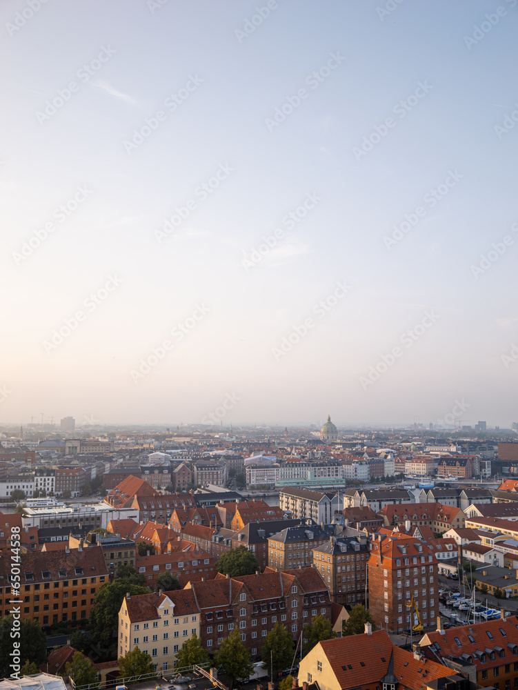 Aerial drone shot of the cityscape of Copenhagen, Denmark during sunset