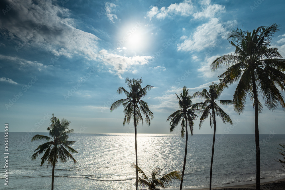 dramatic tropical marine beach landscape over ocean with sunlight. Shot in Lombok, Indonesia