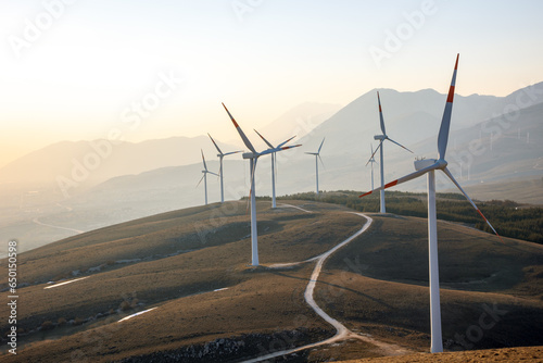 Natural technology of a wind farm with the clouds located in the mountains of Italy Europe and allows to produce clean energy It is sustainable and renewable energy for environment. Italy France 