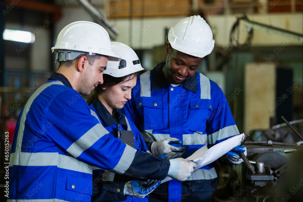 Team worker wearing uniform safety brainstorming holding blueprint plan work management perform working machine at factory. engineer industry work metal product mechanical manufacturing. Team worker wearing uniform safety brainstorming holding blueprint plan work management perform working machine at factory. engineer industry work metal product mechanical manufacturing.