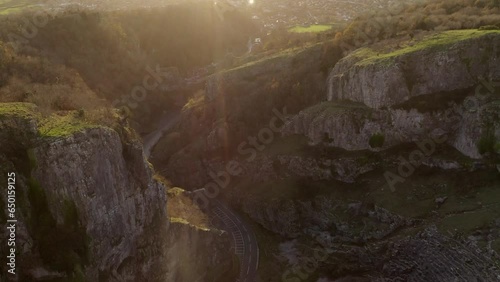 Aerial of Cheddar Gorge limestone rocks and road below with lensflare in Somerset, UK photo