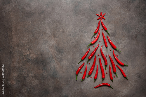 Fotografie Chili pepper in the shape of a Christmas tree on a brown dark background