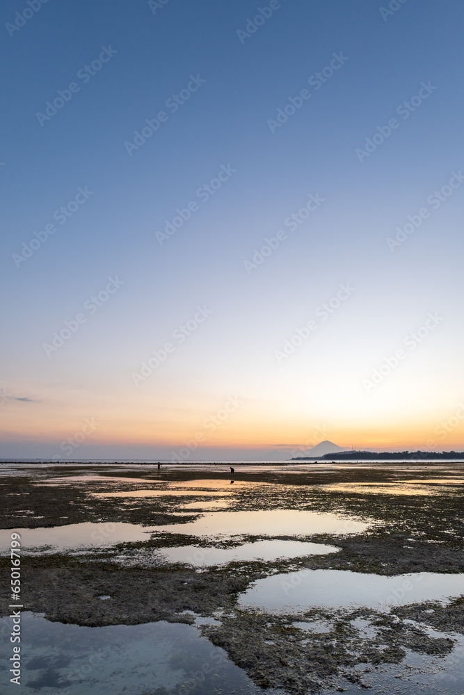 Sunset on Gili Islands, Indonesia. With golden sky and sun at Gili Air beach, Lombok, Indonesia