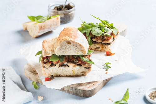 Baguette sandwich with sardines, olive tapenade and ratatouille