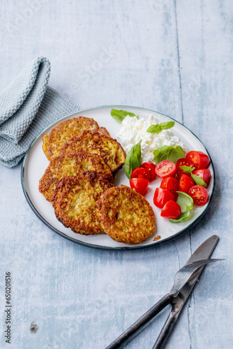 Vegetable pancakes with tomatoes and grainy cream cheese photo