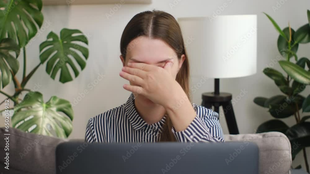 Tired sad female rubbing dry irritable eyes feel eye strain tension migraine after computer work, exhausted young woman worker relieving headache pain, bad weak blurry vision, eyesight problem concept