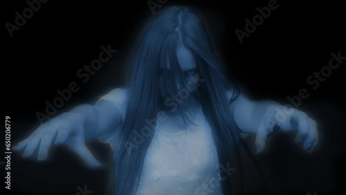 Medium video of a glowing female, woman figure, ghost, poltergeist pulling her hands out to the camera on a black background. photo