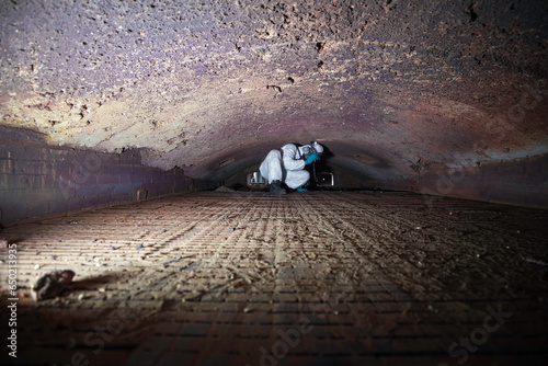 Fotografie Male worker inspecting belt refractory bricks of coil heater gas equipment of boiler room