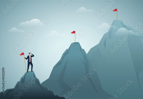 Ambition to success and achieve target, career growth or business goals, challenge to win, achievement or victory concept, motivated businessman reach mountain peak aiming to achieve higher targets.