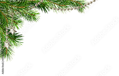 Tela Christmas corner arrangement with green pine twigs and silver garland isolated o
