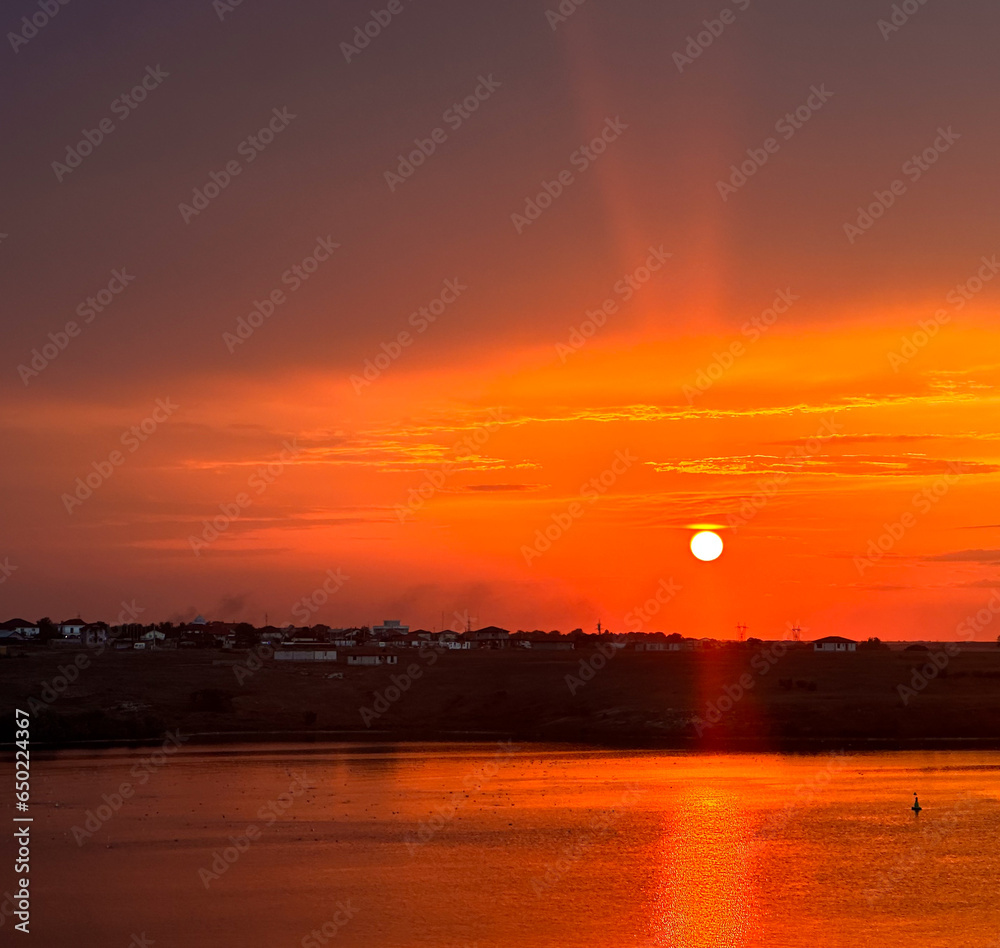 sunset over a lake. the superb reflection of the sun in the lake at sunset. Red. landscape.