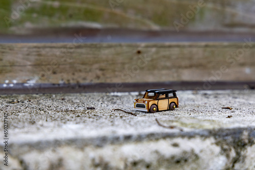 Landscape close up a miniature wooden car on a window ledge