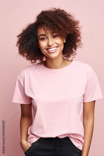 Attractive black woman in pink shirt smiling. © Marharyta
