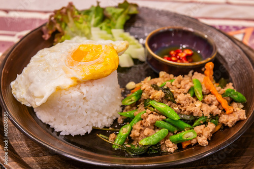 Stir-fried basil or Pad Kra Pao with fried eggs and fish sauce chili is a popular Thai food and is the world's most delicious stir-fry dish of 2023.
