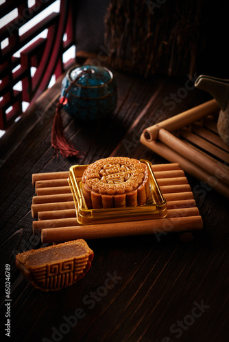 Mooncake Stilllife with chinese dark wood theme with an oriental windows (ID: 650246789)