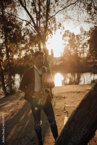 Man playing on saxophone in park photo