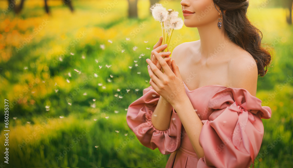 Art photo happy woman holding blowing on dandelion flowers in her hands. Fantasy lady girl princess enjoys nature, fun joyful smiling face lips close-up. Forest green grass lawn trees magic sun light Art photo happy woman holding blowing on dandelion flowers in her hands. Fantasy lady girl princess enjoys nature, fun joyful smiling face lips close-up. Forest green grass lawn trees magic sun light