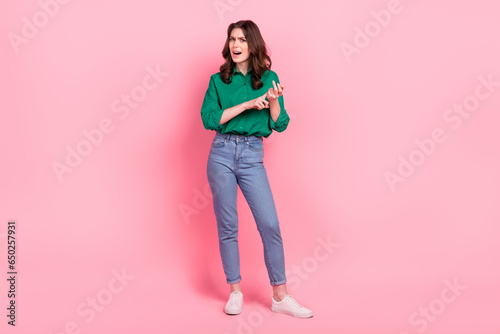 Full length photo of unsatisfied angry bossy person communicate hand fingers count scolding complain isolated on pink color background photo