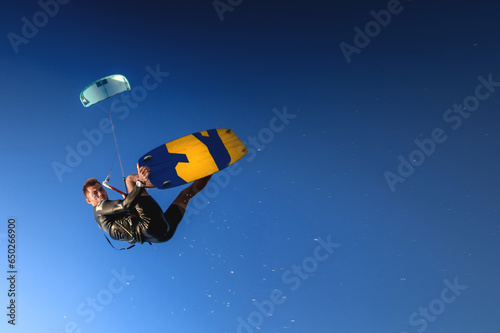 Canvas Print A kitesurfer rides while suspended in the air
